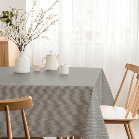 Nagore Gris – Abwaschbare Tischdecke mit klassischem Fischgrätmuster, Ecke